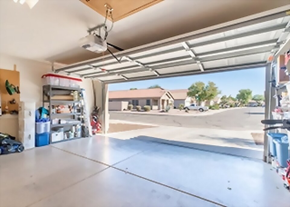 Technician repairing a residential garage door